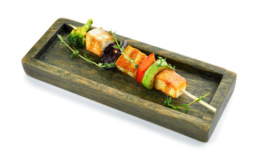Board with grilled tofu cheese skewer on white background
