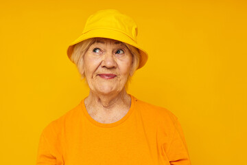 Portrait of an old friendly woman happy lifestyle in a yellow headdress close-up emotions