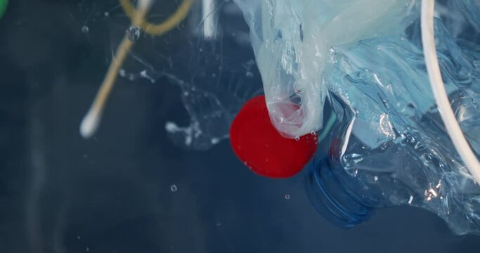 close up plastic waste floating in the water. Environmental hazard, pollution. Garbage on the surface