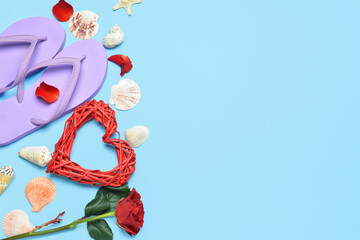 Flip flops, rose, heart and seashells on blue background. Valentine's Day celebration