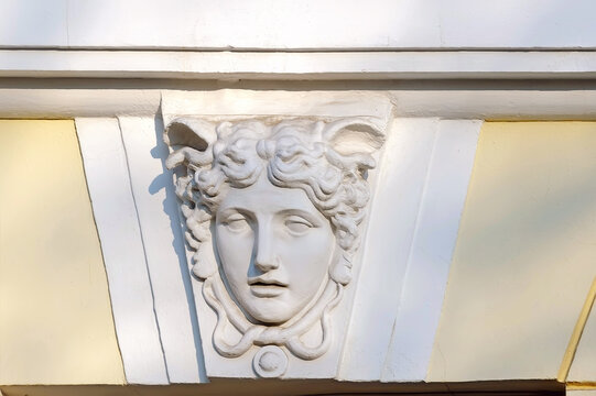 Female mascaron on old building facade in Kyiv Ukraine