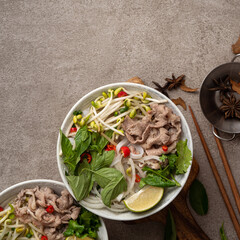 Delicious vietnamese beef noodles pho with ingredients.