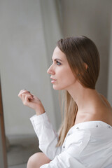 Pretty gentle Caucasian woman happy in white shirt. Daring fashion style portrait of decisive...