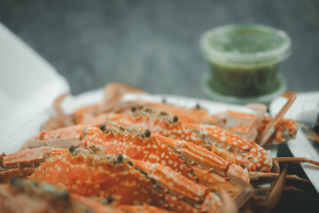 Fresh steamed crab in box with spicy sauce