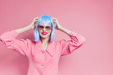 portrait of a woman in sunglasses wears a blue wig makeup isolated background