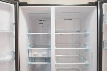 Opened new empty white refrigerator