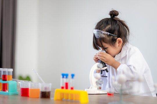 education, science, chemistry and children concept - kids or students with test tube making experiment at school laboratory