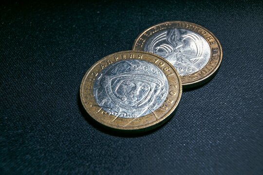 Two coins close-up on a dark background 