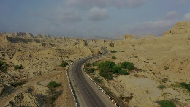 Aerial Along Empty Highway Road Through Rugged Hingol National Park In Balochistan Desert Landscape. Dolly Forward