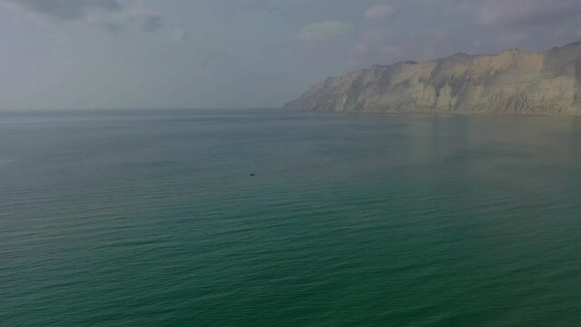 Aerial Over Arabian Sea With Rugged Mountains Of Hingol National Park In Background