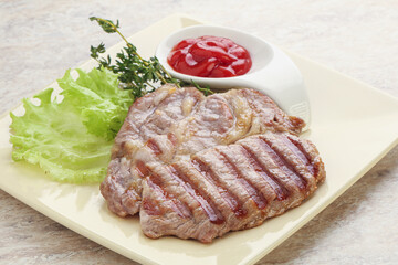 Grilled pork neck steak with ketchup