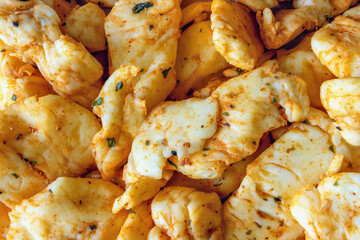 Spicy pieces of cheddar cheese up close