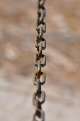 Rusty steel chain shot in perspective with shallow depth of field, soft focus