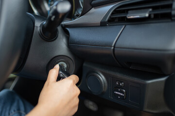 Women's hand turns the key to the car. Hands of the girl to take the keys to start the car engine....