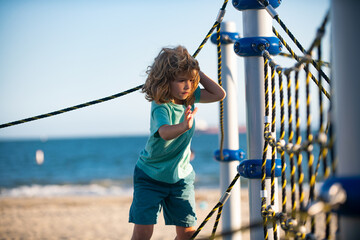 Boy playing in the playground. Kids play outdoor.
