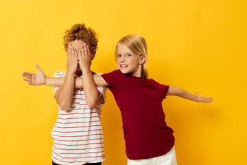 Cute stylish kids cuddling fashion childhood entertainment yellow background