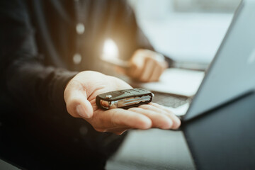 Closeup a car key and money for loan credit financial, lease and rental concept.