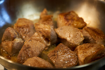 Pork chops searing in the pan