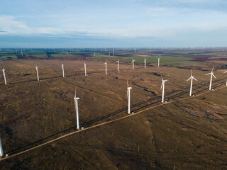 Aerial view of wind turbine farm producing green energy