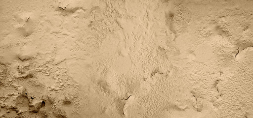 The cement wall is cracked or peeling off of the paint