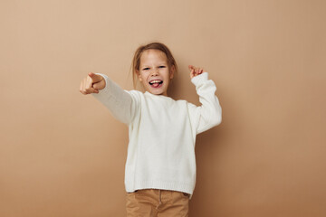 little girl in white sweater posing hand gestures isolated background