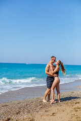 Young attractive man in sunglasses is resting in the pool on summer vacation. The guy in the pool by the hotel