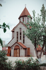 Orthodox Russian temple with red domes against the backdrop of a cloudy gloomy sky