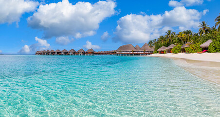 Amazing panorama at Maldives. Luxury resort villas seascape with tropical island coast, shore...