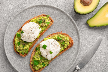 Avocado toast with poached egg in plate top view