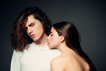 Sensual portrait of young couple in love. Loving couple embracing and kissing.