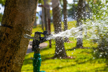 Close-up of automatic sprinkler irrigation sprinklers in the park