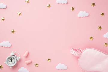 Top view photo of white alarm clock pink silk sleeping mask earplugs golden stars and clouds on isolated pastel pink background with copyspace in the middle