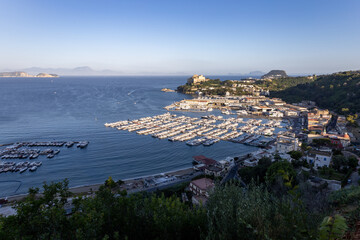 beautiful view of the port of Baia in the Campi Flegrei with Capri island and Sorrento peninsula in the background. Naples, Campania, Italy - obrazy, fototapety, plakaty