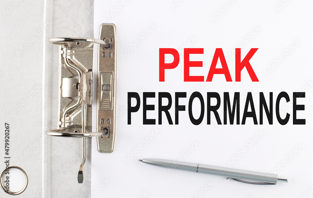 Poster peak performance text on the paper folder with pen. business concept