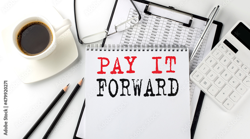 Poster pay it forward text on the paper with calculator, notepad, coffee ,pen with graph