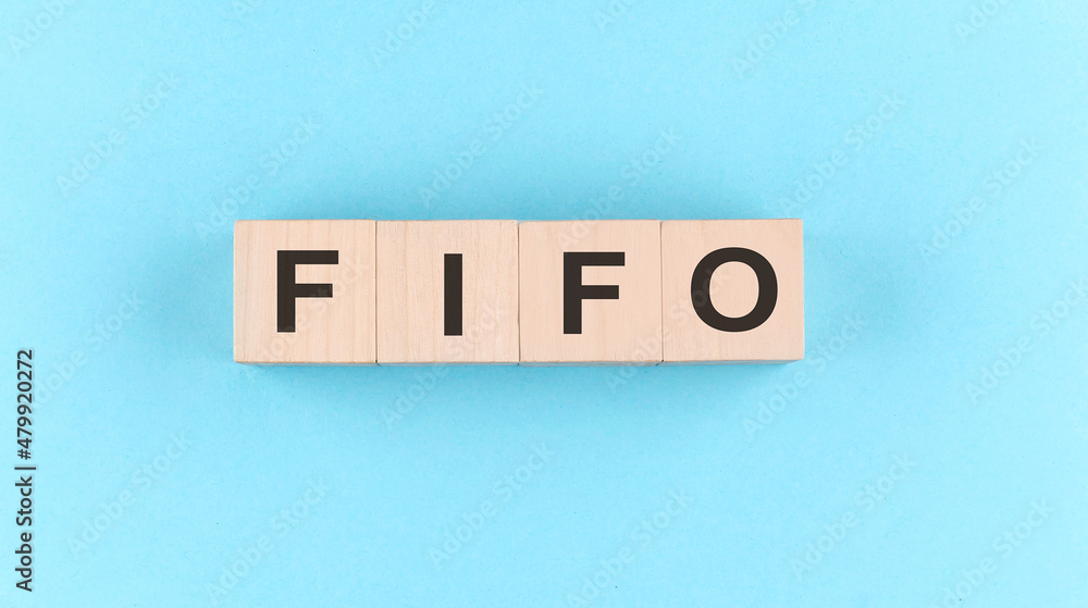 Poster wooden cube block with text fifo on the blue background