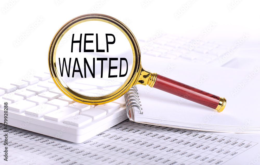 Aufkleber help wanted word through magnifying glass on keyboard on the chart