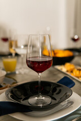Rustic table setting with pink flowers and candle on light wooden table. Holidays decoration on Provence style. Romantic dinner. Overhead