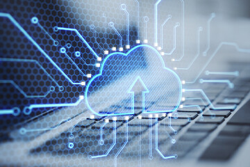 Close up laptop keyboard with abstract glowing cloud and chip interface on blurry background. Cloud computing, technology and database. Double exposure.