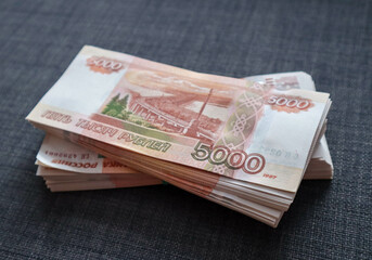 Two wads of money lying on the couch