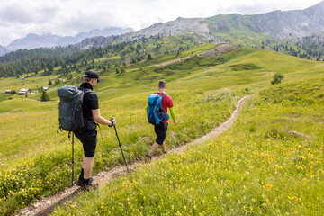 Two hikers on a hiking trail in the Dolomite Alps