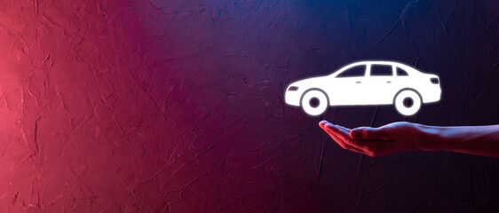 Male hand holding car auto icon on blue background. Wide banner composition.Car automobile...