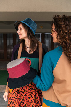 Electic women friends spending free time together on city