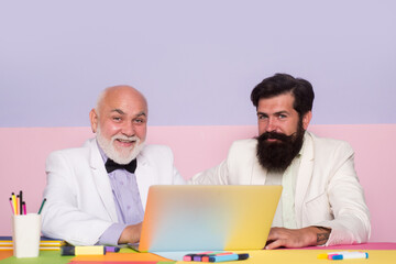 Obraz premium Smiling coworker of businessman working at office workplace. Businessmen with laptop at work.