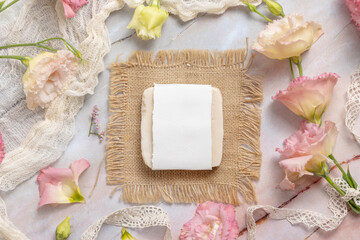 Soap bar on laying on marble table near a pink flowers
