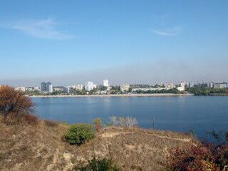 View from the shores of the island of Khortytsia on the Dnieper industrial city of Zaporozhye covered with a cloud of factory emissions on the horizon.