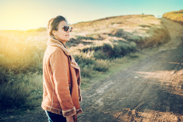 Naklejka premium close up of a young woman on the road, latin woman on a highway road, portrait of a woman on a road, woman on a road
