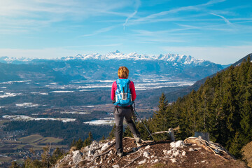 Back view of woman hiker enjoying the view on a mountain. Freedom and happiness.