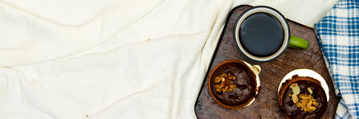macarons with cup of coffee on wooden board in bed 