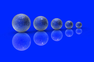 Five balls of metal of different sizes of blue color on blue background. Growth of something. Progress. Reflection. Horizontal image. 3D image. 3D rendering.